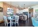 A dining area and kitchen with white cabinets, stainless steel appliances, and a black countertop at 8812 Grand Ave, Placida, FL 33946