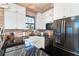 A kitchen area with white cabinets, stainless steel appliances, and a black countertop at 8812 Grand Ave, Placida, FL 33946