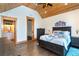 Cozy main bedroom featuring hardwood floors, wood ceiling, and an ensuite bathroom for added convenience at 8812 Grand Ave, Placida, FL 33946