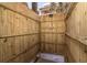 Outdoor shower featuring wood paneling with shower head and faucet hardware at 8812 Grand Ave, Placida, FL 33946