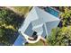 Aerial view shows nice driveway, landscaping, roof, and pool at 941 Elwood Ave, Englewood, FL 34223