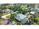 Aerial view of house surrounded by mature trees with screened pool at 941 Elwood Ave, Englewood, FL 34223