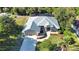 Aerial view of a well-maintained single-Gathering home with lush landscaping and a private driveway at 941 Elwood Ave, Englewood, FL 34223