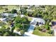 Aerial view of a lovely home surrounded by beautiful trees in a quiet neighborhood at 941 Elwood Ave, Englewood, FL 34223