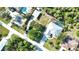 Home and surrounding neighborhood with mature trees and maintained lawns at 941 Elwood Ave, Englewood, FL 34223