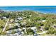 Aerial view of the house surrounded by trees, RV parking, and outbuilding near the water at 941 Elwood Ave, Englewood, FL 34223