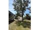 Spacious backyard featuring a large tree, an RV, a utility shed, and a chain-link fence at 941 Elwood Ave, Englewood, FL 34223
