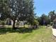 Expansive backyard with chain-link fencing, mature trees, and additional storage shed at 941 Elwood Ave, Englewood, FL 34223