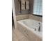 Bathroom featuring a large tub with stylish tile surround, perfect for relaxing at 941 Elwood Ave, Englewood, FL 34223