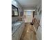 Bathroom has granite countertop vanity, mirror, and tub and shower with tiled flooring at 941 Elwood Ave, Englewood, FL 34223