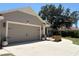 Inviting two-car garage with an extended driveway and landscaped walkway leading to the front door at 941 Elwood Ave, Englewood, FL 34223