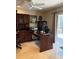 Home office with custom wood desk and cabinetry featuring a large window with natural light at 941 Elwood Ave, Englewood, FL 34223