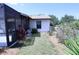Side view of the home's exterior and backyard landscaping at 10275 Euston Ave, Englewood, FL 34224