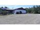 Large backyard showcasing the home's exterior, patio, and minimal landscaping at 10275 Euston Ave, Englewood, FL 34224