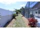 A view of the backyard with a screened-in pool, landscaping, and privacy fencing at 10275 Euston Ave, Englewood, FL 34224