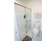 Clean bathroom with a shower and sliding glass doors next to the white toilet at 10275 Euston Ave, Englewood, FL 34224