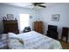 Bright bedroom featuring a ceiling fan, window, and wood furniture, creating a cozy atmosphere at 10275 Euston Ave, Englewood, FL 34224