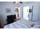 Bright bedroom features a ceiling fan, wood floors, and access to a kitchen and bathroom at 10275 Euston Ave, Englewood, FL 34224
