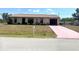 Charming single-story home featuring a well-kept lawn and quaint nautical decor at 10275 Euston Ave, Englewood, FL 34224