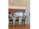 Breakfast bar with three chairs overlooking the kitchen at 10275 Euston Ave, Englewood, FL 34224