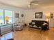 Inviting living room featuring wood floors, a ceiling fan, and a comfortable seating area at 10275 Euston Ave, Englewood, FL 34224