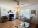 Comfortable living room with a ceiling fan, natural light, and wood-look flooring at 10275 Euston Ave, Englewood, FL 34224