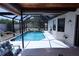 A screened-in pool with a covered patio and plenty of room for seating and entertaining at 10275 Euston Ave, Englewood, FL 34224