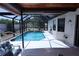 A screened-in pool with a covered patio and plenty of room for seating and entertaining at 10275 Euston Ave, Englewood, FL 34224