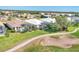 An aerial shot featuring lush green golf course, homes with screened lanais, and scenic views at 105 Westwind Dr, Placida, FL 33946