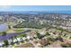 Aerial view of golf course community featuring lush greenery and sparkling blue water at 105 Westwind Dr, Placida, FL 33946