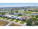 Aerial view of a serene neighborhood featuring golf course, a lake, and well-maintained homes at 105 Westwind Dr, Placida, FL 33946