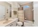 Cozy bathroom features a shower, a neutral curtain, a sink with storage, and coordinated towel racks at 105 Westwind Dr, Placida, FL 33946