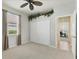 Bedroom has a ceiling fan, closet, window, and door, creating a functional yet welcoming space at 105 Westwind Dr, Placida, FL 33946