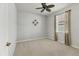 Neutral bedroom with a fan, carpet, and window providing an adaptable and serene space at 105 Westwind Dr, Placida, FL 33946
