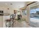 Cozy dining area next to the kitchen with a view of the screened-in pool area at 105 Westwind Dr, Placida, FL 33946