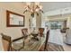 Dining area with a glass table, view of the pool, and open access to the living room at 105 Westwind Dr, Placida, FL 33946