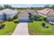 Charming single-story home featuring lush landscaping, tile roof, and a well-manicured lawn at 105 Westwind Dr, Placida, FL 33946