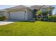 Charming single-story home showcasing a well-maintained lawn and beautiful landscaping at 105 Westwind Dr, Placida, FL 33946