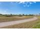 A picturesque view of a well-maintained golf course, lush greenery, and a cozy home in the background at 105 Westwind Dr, Placida, FL 33946