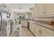 Well-lit kitchen with white cabinetry, stainless appliances, and views of the outdoor dining area at 105 Westwind Dr, Placida, FL 33946