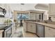 Modern kitchen with stainless appliances, counter seating, and views to the outdoor patio at 105 Westwind Dr, Placida, FL 33946