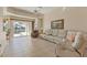 Spacious living room with sliding doors to lanai with a pool and neutral decor at 105 Westwind Dr, Placida, FL 33946
