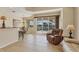 Inviting living area with tiled floors, sliders to lanai with pool and an adjacent dining area at 105 Westwind Dr, Placida, FL 33946