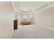 Spacious living room boasts a tray ceiling, fan, and large windows, creating a bright, inviting atmosphere at 105 Westwind Dr, Placida, FL 33946