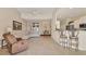 Open living room with tile floors, modern furniture, and a view of the dining area and kitchen at 105 Westwind Dr, Placida, FL 33946