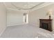 Spacious living room featuring a tray ceiling, modern fireplace, and neutral carpeting for a comfortable ambiance at 105 Westwind Dr, Placida, FL 33946