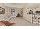 Bright and airy living area with tiled floors, neutral walls, bar and dining area at 105 Westwind Dr, Placida, FL 33946