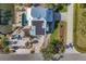 Aerial view of a waterfront home with a pool, hot tub, beach, and solar panels at 10500 Sherman St, Englewood, FL 34224