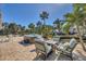 Outdoor oasis with hot tub, fire pit, lush greenery, and waterfront access at 10500 Sherman St, Englewood, FL 34224