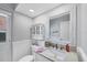 Bathroom boasts updated vanity with granite counters, framed mirror, and charming storage cabinet at 10500 Sherman St, Englewood, FL 34224